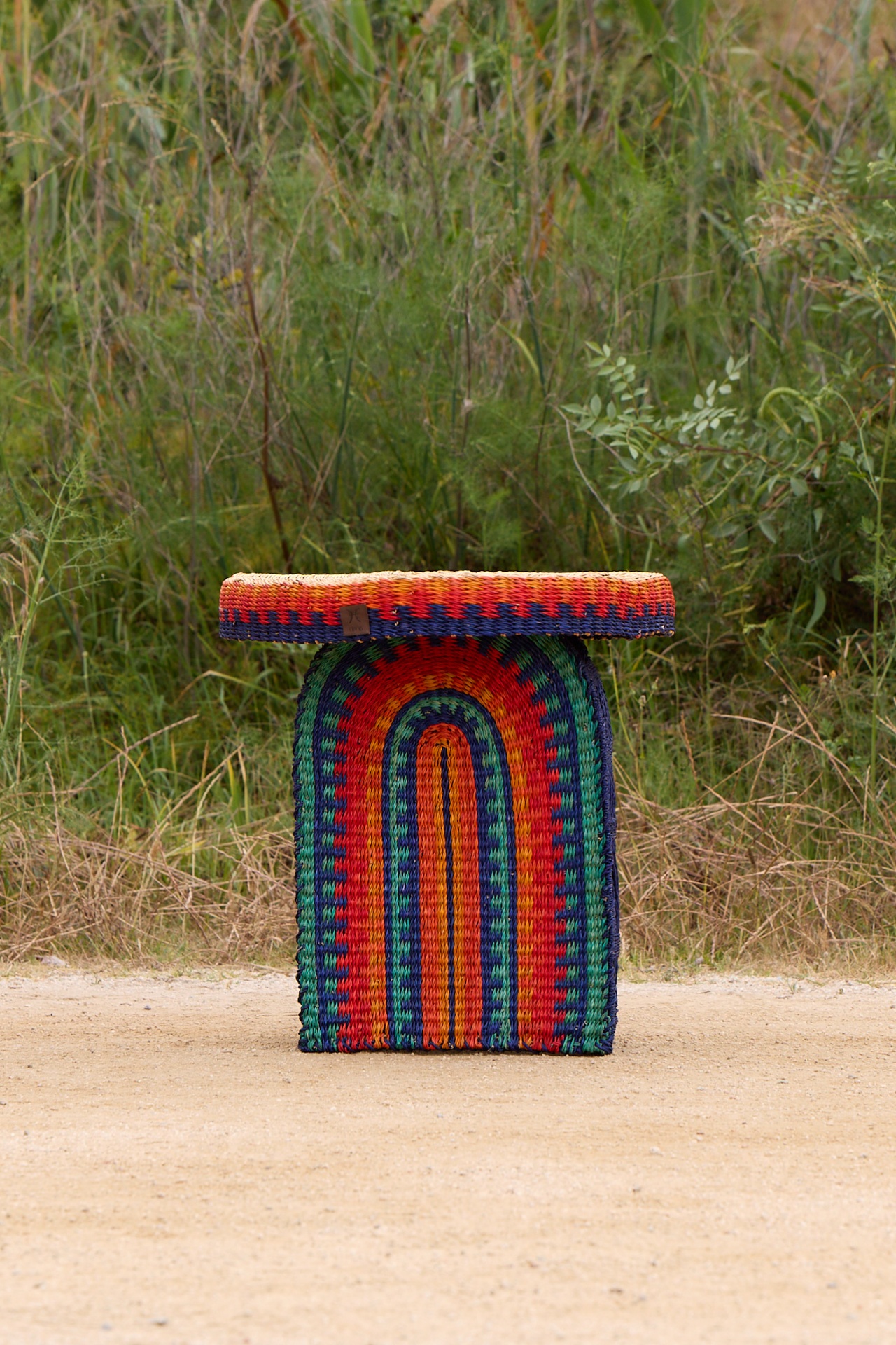 Amira table with handwoven elephant grass in rainbow colours