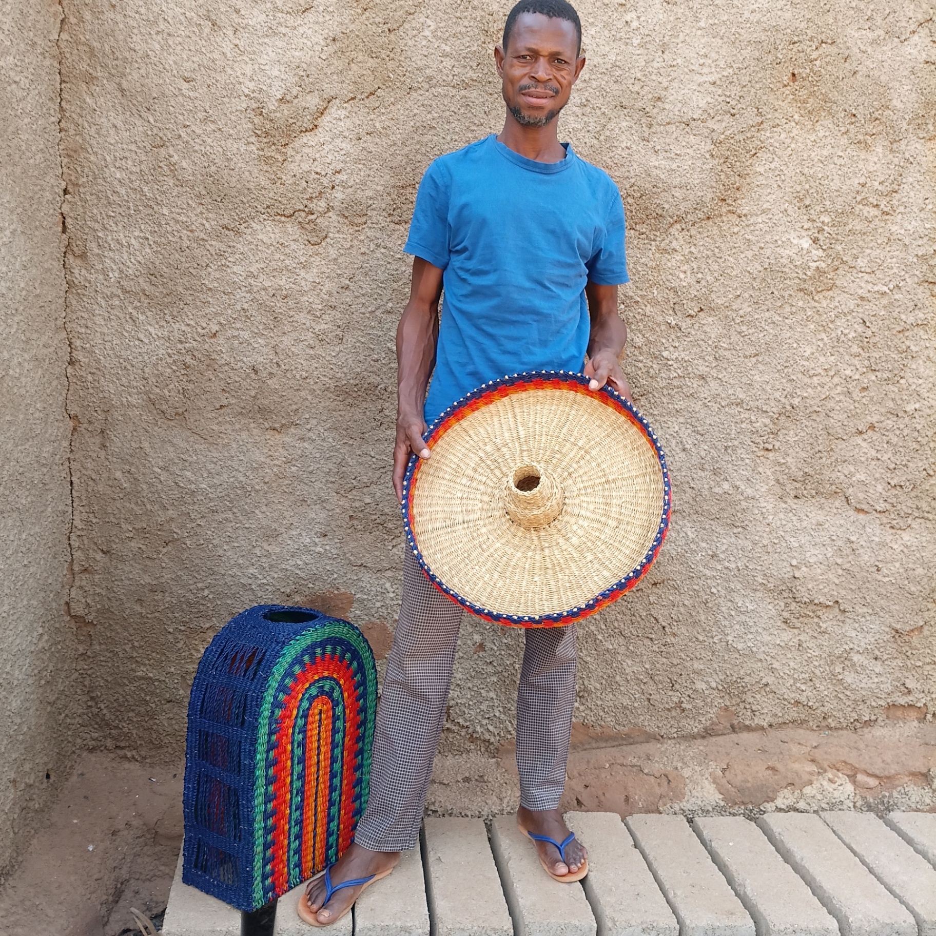 Artisan weaving the elephant grass onto the metal frame