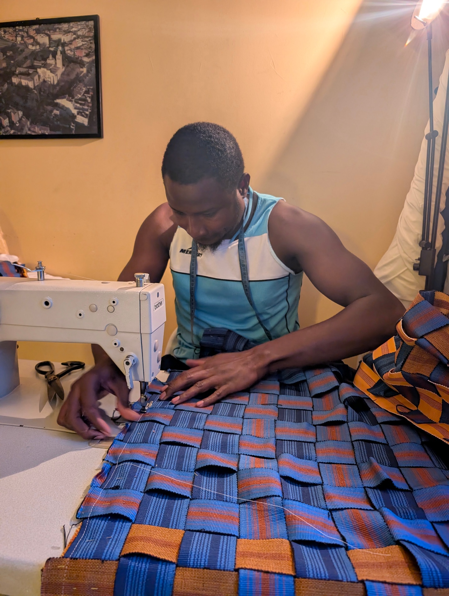 Artisan loom-weaving the rug in Bolgatanga