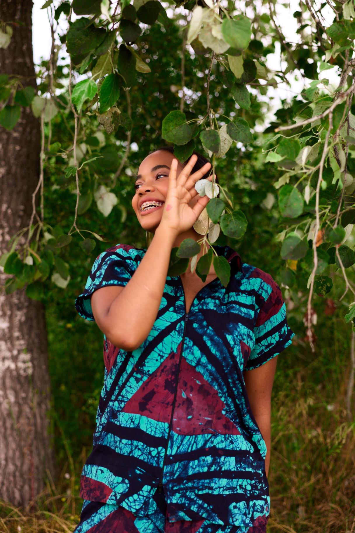 Close-up of the Ife Batik Co-ord top showing the geometric maroon and teal batik print