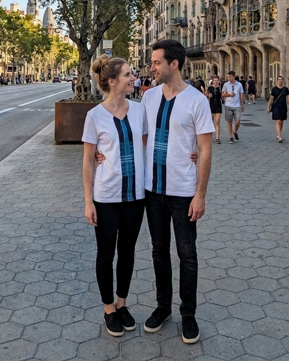 Couple wearing the Blue Asooke unisex tee on Passeig de Gracia in Barcelona