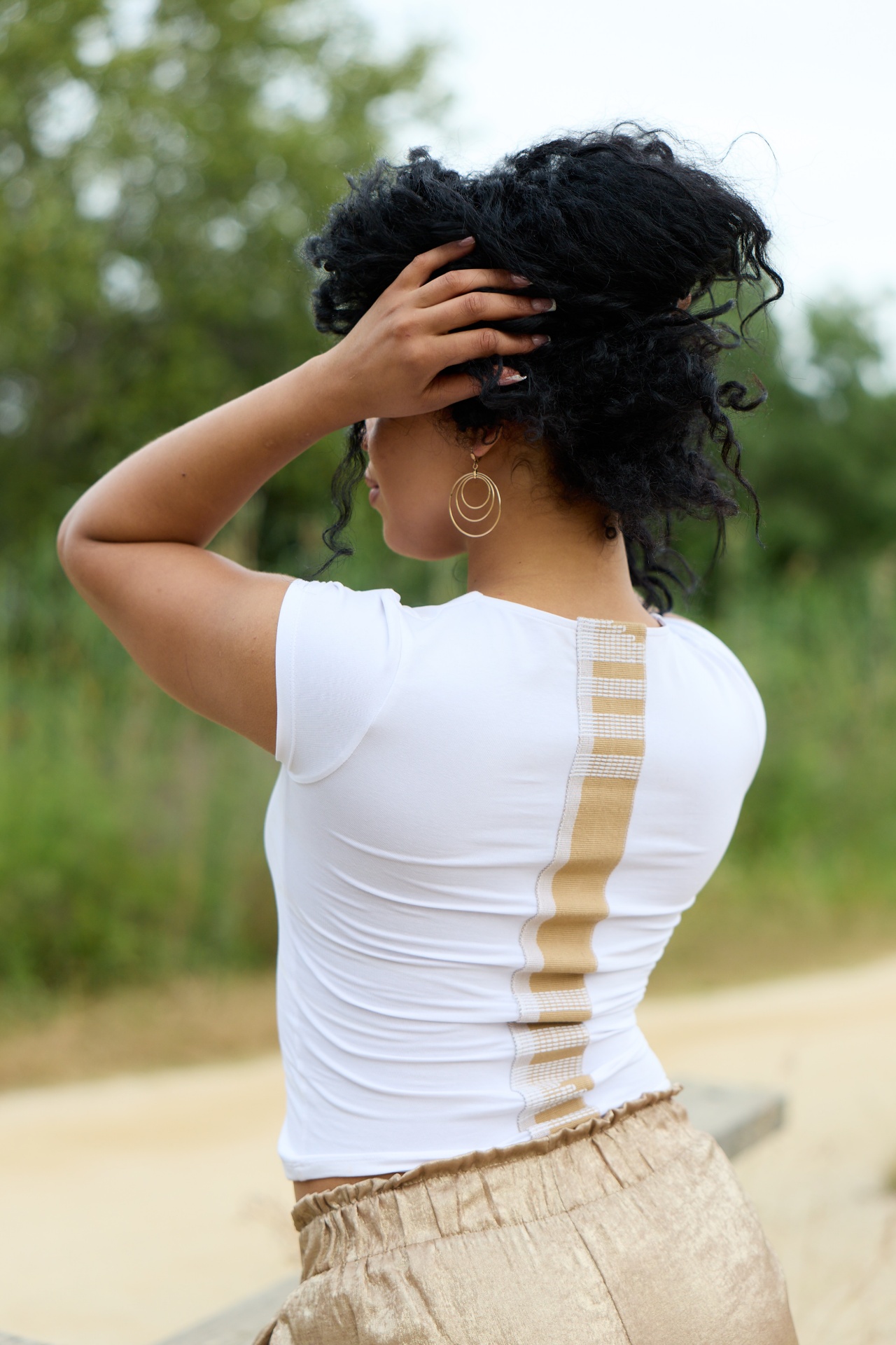 Ivory Loom Tee — close-up of the back showing the handwoven ivory and white Asooke strip running top to bottom on a white cotton slim-fit t-shirt
