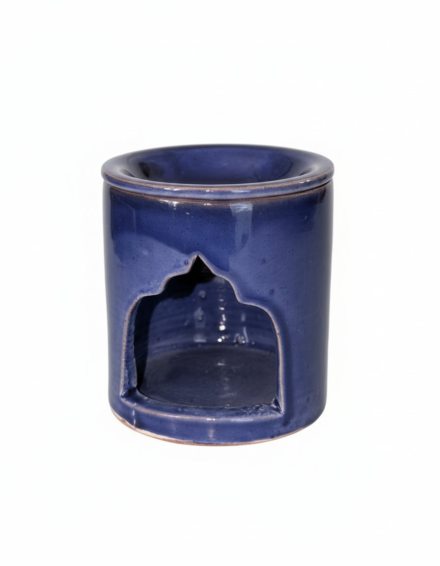 Blue glazed Moroccan ceramic oil burner on white background